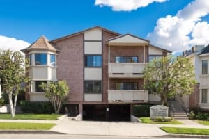 Exterior front view of Cypress Venture Apartments in Burbank, CA featuring bay windows, balconies, and gated parking.